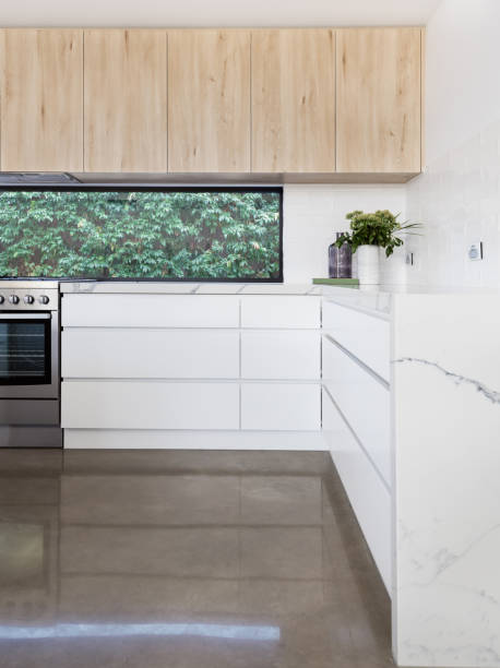 Kitchen details of concrete floor and oversized soft close drawers